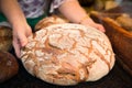 Baker displays loaf of fresh crusty bread