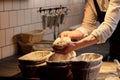 Baker with dough rising in baskets at bakery Royalty Free Stock Photo