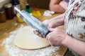 Baker flouring a rolling pin to prep for sugar cookies