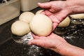 Baker forming bagels from dough