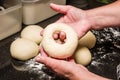 Baker forming bagels from dough