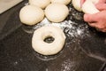 Baker forming bagels from dough