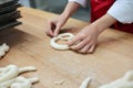 Baker forming pretzels from dough