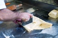 Baker forming and shaping dough with a blade