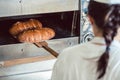 Baker getting fresh bread with shovel out of oven Royalty Free Stock Photo