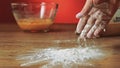 Baker hand throwing flour on the table, slow motion, 240 fps. Cooking and backing preparation. Food preparation on the