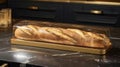 a baker handing baked baguette crafted with care, encased in a golden and glass packaging, within the cozy ambiance of a