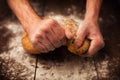 Baker hands with fresh bread on table