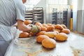 Baker hands lay fresh bread at the bakery.