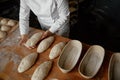 Baker hands preparing formed bread dough for proofing Royalty Free Stock Photo