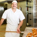 Baker in his bakery baking bread Royalty Free Stock Photo