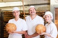 Baker with his team in bakery Royalty Free Stock Photo