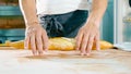 Baker holding fresh bread for tearing it on a half. Male hands holds baguette Royalty Free Stock Photo