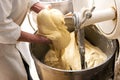 Baker holding a mound of raw dough in his hands