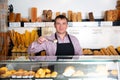 Baker holding out freshly baked cupcake Royalty Free Stock Photo