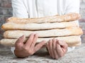 Baker holding traditional bread french baguettes Royalty Free Stock Photo