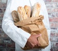 Baker holding traditional bread french baguettes Royalty Free Stock Photo