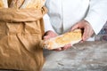 Baker holding traditional bread french baguettes Royalty Free Stock Photo