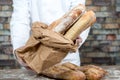 Baker holding traditional bread french baguettes Royalty Free Stock Photo