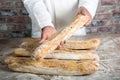 Baker holding traditional bread french baguettes Royalty Free Stock Photo