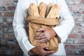Baker holding traditional bread french baguettes Royalty Free Stock Photo