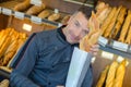 Baker holding up baguette Royalty Free Stock Photo