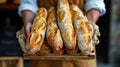 Baker holds fresh baked French baguettes. Homemade sourdough bread Royalty Free Stock Photo