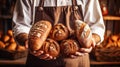 The baker holds fresh bread in his hands. Generative AI.