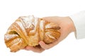 Baker holds a fresh bun in the hands of, isolated on white background Royalty Free Stock Photo