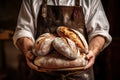 baker holds fresh, fragrant, delicious bread in his hand