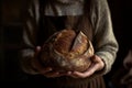 A baker holds freshly baked bread 2