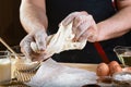 Baker knead dough bread, pizza or pie recipe ingredients with hands, food on kitchen table background, working with milk, yeast, f Royalty Free Stock Photo