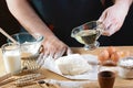 Baker knead dough bread, pizza or pie recipe ingredients with hands, food on kitchen table background, working with milk, yeast, f Royalty Free Stock Photo