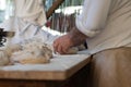 Baker knead the dough on a table