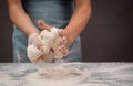 Baker kneading dough for artisan bread or pizza with his hands, prepare ingredients for food, baking pastry Royalty Free Stock Photo