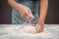 Baker kneading dough for pizza or artisan bread with his hands, prepare ingredients for food, baking pastry Royalty Free Stock Photo