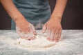 Baker kneading dough for pizza or artisan bread with his hands, prepare ingredients for food, baking pastry Royalty Free Stock Photo