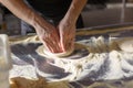 Baker kneads dough for pizza in the kitchen in the restaurant Royalty Free Stock Photo