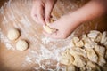 Baker kneads uncooked dough on a wooden table Royalty Free Stock Photo