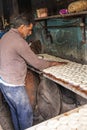 Baker making bagel shaped bread rolls