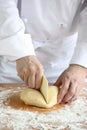 Baker making bread,cutting a dough Royalty Free Stock Photo