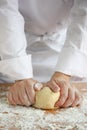 Baker making bread, kneading a dough