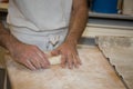 Baker making bread , man hands , kneading a dough , cooking coat Royalty Free Stock Photo