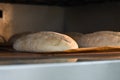 Baker making bread , man hands , kneading a dough , cooking coat.The concept of small bakeries, craft traditional bread Royalty Free Stock Photo