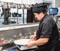 Baker making pizza at the pizzeria kitchen