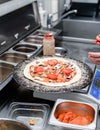 Baker making pizza at the pizzeria kitchen Royalty Free Stock Photo