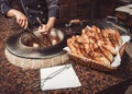 Baker making turkish pita bread in tandoor clay oven. Baking process. Royalty Free Stock Photo