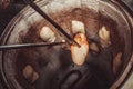 Baker making turkish pita bread in tandoor clay oven. Baking process. Royalty Free Stock Photo