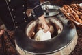 Baker making turkish pita bread in tandoor, clay oven. Baking process. Many fresh hot bread in the basket. Royalty Free Stock Photo