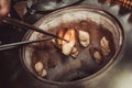 Baker making turkish pita bread in tandoor, clay oven. Baking process. Many fresh hot bread in the basket. Royalty Free Stock Photo